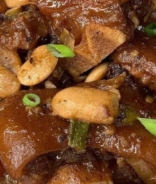 Jamaican stewed cow foot and beans served with your choice of rice dish –  serves two
