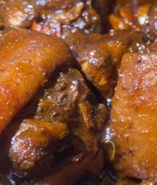 Jamaican  brown  stew belly Pork served with your choice of Rice dishes  – serves two